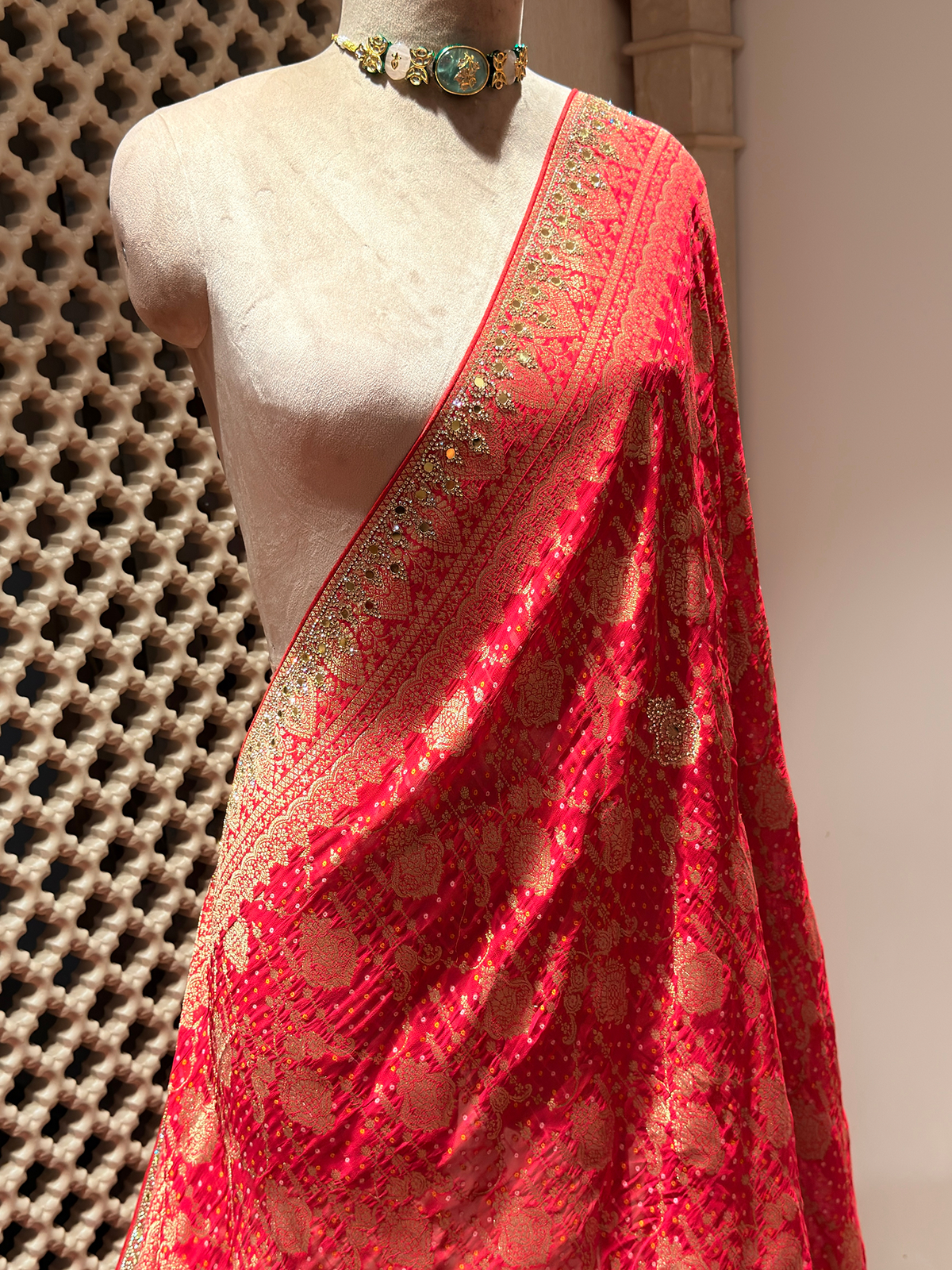 Radiant Red Khaddi Georgette Saree adorned with Mirror Work & Bandhani Weave - Unstitched Blouse