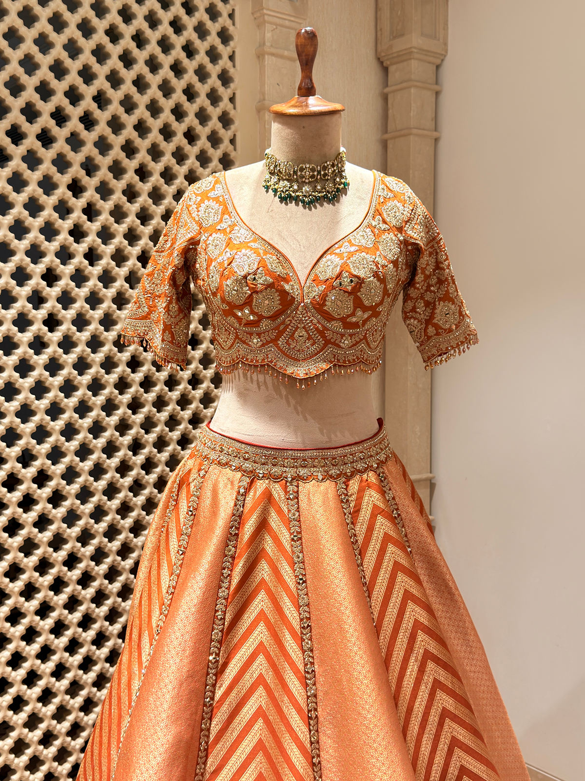 Sunset Orange Brocade Silk Lehenga with Chevron Weave & Mirror Zarkan Work