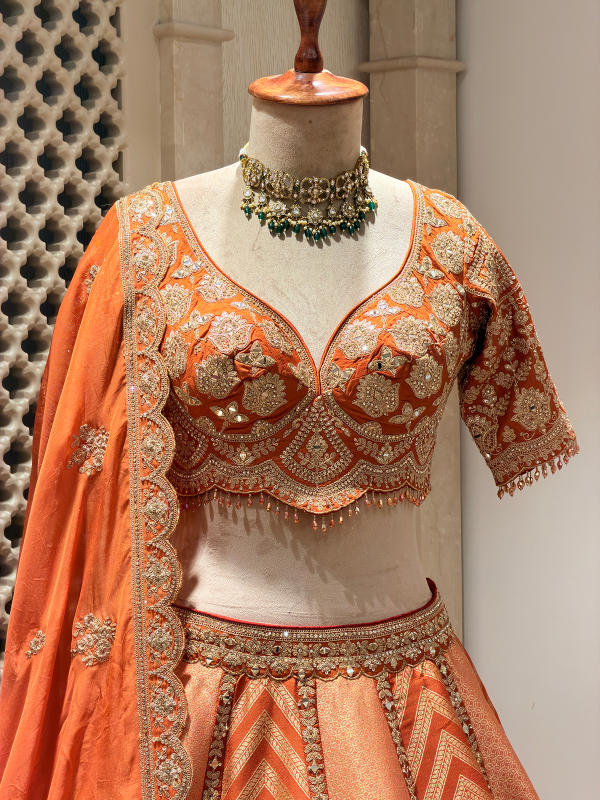 Sunset Orange Brocade Silk Lehenga with Chevron Weave & Mirror Zarkan Work
