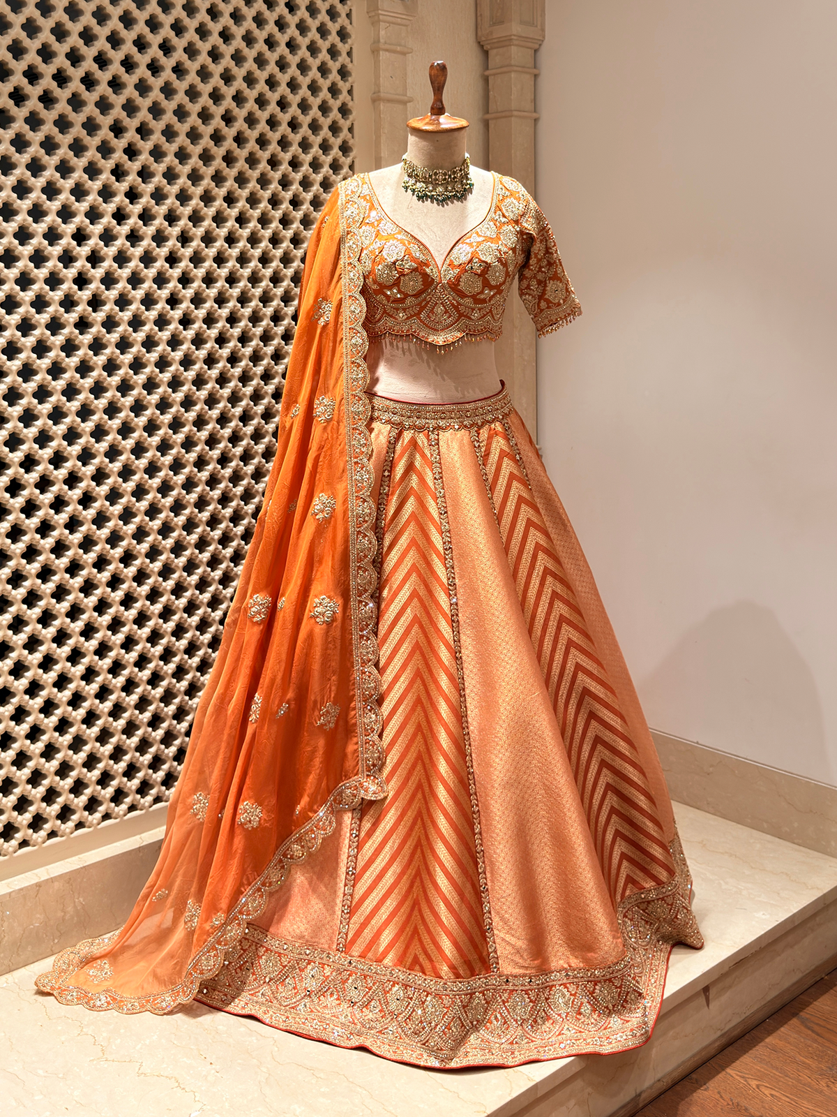 Sunset Orange Brocade Silk Lehenga with Chevron Weave & Mirror Zarkan Work